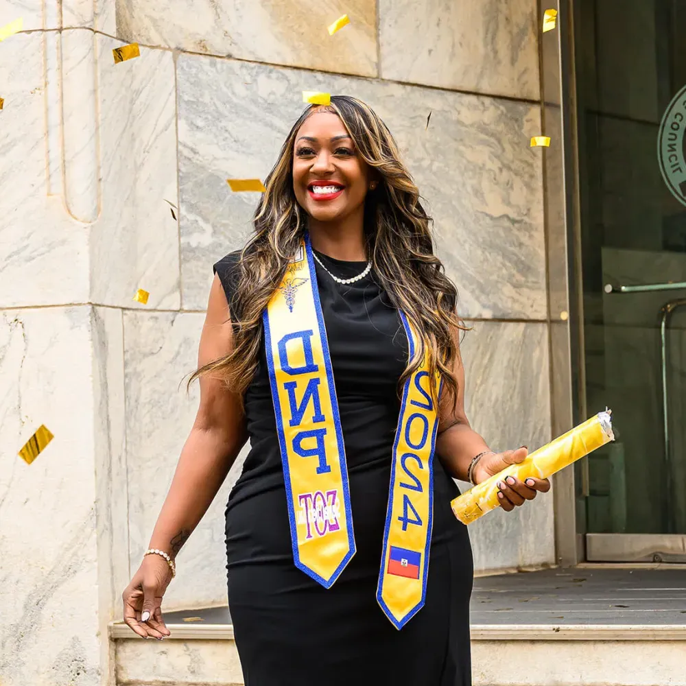 Herzing DNP graduate Carla Bourelly smiling with diploma